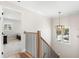 Elegant staircase with wood and iron railing, pendant light, and view of a carpeted second floor at 10160 Mallard Landings Way, Orlando, FL 32832