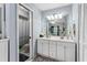 Bathroom boasts dual sink vanity, large mirror, and a door leading to the commode and shower at 1017 Love Ln # 34, Apopka, FL 32703