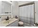 This bathroom includes a vanity with updated fixtures, along with a shower and tub combination featuring a decorative curtain at 1017 Love Ln # 34, Apopka, FL 32703