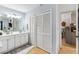 Bathroom featuring double sink vanity, a three-bulb vanity light, and door into kitchen at 1017 Love Ln # 34, Apopka, FL 32703