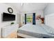 Cozy main bedroom featuring hardwood floors, large window, ceiling fan, and light blue accent wall at 1017 Love Ln # 34, Apopka, FL 32703