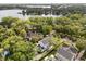 An aerial view captures the property's picturesque setting with lush trees and proximity to a serene lake at 104 Cortland Ave, Winter Park, FL 32789