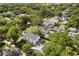 Stunning aerial view of home with lush landscaping, pool, and mature trees at 104 Cortland Ave, Winter Park, FL 32789