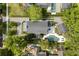 Aerial view showcases the property's layout, including the main house, pool area, and lush landscaping at 104 Cortland Ave, Winter Park, FL 32789