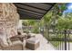Brick balcony featuring wicker seating, black awning and iron railing at 104 Cortland Ave, Winter Park, FL 32789