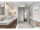 Bathroom featuring natural light, shower, marble walls and double sink vanity at 104 Cortland Ave, Winter Park, FL 32789