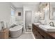 Bright bathroom featuring tub, natural light, double sink vanity and neutral colors at 104 Cortland Ave, Winter Park, FL 32789