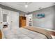 Neutral bedroom with hardwood floors, bed, TV, and doorways to bathroom and hallway at 104 Cortland Ave, Winter Park, FL 32789