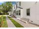 Side exterior view showcases the beautiful landscaping, architectural details, and well-maintained grounds at 104 Cortland Ave, Winter Park, FL 32789