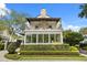 Charming two-story home featuring a balcony, manicured lawn, and brick accents at 104 Cortland Ave, Winter Park, FL 32789