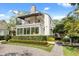 Charming two-story home featuring a balcony, manicured lawn, and brick accents at 104 Cortland Ave, Winter Park, FL 32789