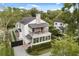 Charming two-story home featuring a balcony, covered patio, and manicured landscaping at 104 Cortland Ave, Winter Park, FL 32789