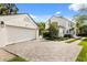 The property features a large driveway, and a well-maintained lawn, enhancing the home's curb appeal and functionality at 104 Cortland Ave, Winter Park, FL 32789