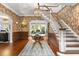 Elegant foyer with patterned wallpaper, a decorative chandelier, and a staircase to the upper level at 104 Cortland Ave, Winter Park, FL 32789