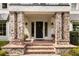 Inviting front entrance with brick columns, landscaped garden, and stone walkway at 104 Cortland Ave, Winter Park, FL 32789