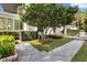 Landscaped front yard with manicured hedges, stone walkway, and lush greenery at 104 Cortland Ave, Winter Park, FL 32789