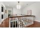 Bright hallway featuring hardwood floors, white wainscotting, and a decorative chandelier at 104 Cortland Ave, Winter Park, FL 32789