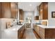Modern kitchen features quartz counters, wooden cabinets and hardwood floors at 104 Cortland Ave, Winter Park, FL 32789