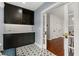 Laundry room with overhead cabinets, stylish tile floor, and a view to the hall at 104 Cortland Ave, Winter Park, FL 32789