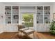 A comfortable chair sits beside built in bookshelves and a window providing lots of light at 104 Cortland Ave, Winter Park, FL 32789