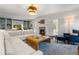 Bright living room features a fireplace, hardwood floors, a decorative light fixture, and built-in bookcases at 104 Cortland Ave, Winter Park, FL 32789