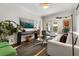 Bright living space with white trim and decor, light gray sofa, and an eye-catching rug at 104 Cortland Ave, Winter Park, FL 32789