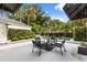 Outdoor patio with seating around a private pool, lush landscaping, and privacy hedges, providing a serene outdoor space at 104 Cortland Ave, Winter Park, FL 32789