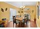 Formal dining room with hardwood floors, chandelier, and window at 1040 Big Oaks, Oviedo, FL 32765