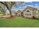 Lovely single-story home with green lawn and American flag at 1040 Big Oaks, Oviedo, FL 32765