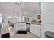 Bright kitchen with white cabinets, granite counters, and stainless steel dishwasher at 1040 Big Oaks, Oviedo, FL 32765