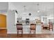 Bright kitchen features granite counters, stainless appliances, and seating at breakfast bar at 1040 Big Oaks, Oviedo, FL 32765
