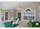 Covered patio with ceiling fans, chairs, and serene outdoor space at 1040 Big Oaks, Oviedo, FL 32765