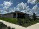 A serene backyard view with a covered patio, green shrubbery, and plenty of space for outdoor enjoyment at 1141 Lakeshore Breeze Pl, Kissimmee, FL 34747