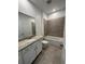 Bathroom includes vanity sink, toilet, and shower-tub combo with tile surround at 1141 Lakeshore Breeze Pl, Kissimmee, FL 34747