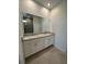 Bathroom features double sinks with granite countertop and tile floor at 1141 Lakeshore Breeze Pl, Kissimmee, FL 34747