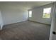 Spacious carpeted bedroom with two windows for ample natural light at 1141 Lakeshore Breeze Pl, Kissimmee, FL 34747