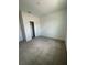 Neutral-toned bedroom with carpeted floor has a closet with a bi-fold door at 1141 Lakeshore Breeze Pl, Kissimmee, FL 34747