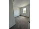 Bedroom with neutral carpet, white walls, and a window with natural light at 1141 Lakeshore Breeze Pl, Kissimmee, FL 34747
