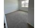 Bedroom with neutral carpet, white walls, and a window with natural light at 1141 Lakeshore Breeze Pl, Kissimmee, FL 34747