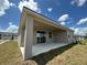 Covered patio with sliding glass doors, ideal for outdoor entertaining at 1141 Lakeshore Breeze Pl, Kissimmee, FL 34747
