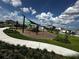 Neighborhood playground featuring modern equipment, shaded areas, and lush landscaping for outdoor fun at 1141 Lakeshore Breeze Pl, Kissimmee, FL 34747