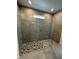 Large glass-enclosed shower with gray tiling and mosaic tile floor at 1141 Lakeshore Breeze Pl, Kissimmee, FL 34747