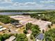 An aerial view displays the property's location near a serene lake at 1190 Pecan St, Kissimmee, FL 34744