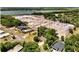 Aerial view of a construction site with large warehouses, surrounded by trees and a body of water at 1190 Pecan St, Kissimmee, FL 34744