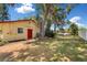 Backyard exterior with a shed, mature trees, and well-maintained grass at 1190 Pecan St, Kissimmee, FL 34744