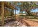 Charming backyard featuring a pergola with bench seating and natural landscaping at 1190 Pecan St, Kissimmee, FL 34744
