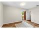 Bright bedroom featuring wood-look floors, neutral walls, an area rug, and a door to the outside at 1190 Pecan St, Kissimmee, FL 34744