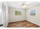 Bright bedroom with two windows, a ceiling fan, and wood-look flooring at 1190 Pecan St, Kissimmee, FL 34744