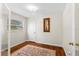 A cozy bedroom featuring hardwood floors and a framed painting, illuminated by natural light from a window at 1190 Pecan St, Kissimmee, FL 34744