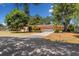 Charming home with a well-kept lawn, mature trees and a two-car garage at 1190 Pecan St, Kissimmee, FL 34744